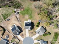 Aerial view of a neighborhood with well-maintained houses with solar panels and tree coverage at 8137 Bryson Rd, Fort Mill, SC 29707
