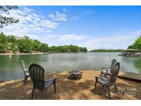 Beautiful lakeside view featuring patio seating area with lake access with space for entertaining at 121 Rhinehill Dr, Mooresville, NC 28117