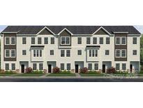 Three-story townhome features a light siding exterior with dark accents and multiple windows offering plenty of natural light at 226 E Morehouse Ave # Twnh A, Mooresville, NC 28117