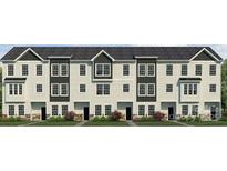 View of new townhomes with light siding, dark accents, stone detail, and manicured lawns at 226 E Morehouse Ave # Twnh B, Mooresville, NC 28117
