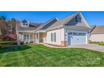 Charming home with a well-maintained lawn, inviting front porch, and attached two-car garage at 229 River Birch Dr, Salisbury, NC 28146