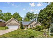 Charming single-story home featuring an attached two-car garage and inviting curb appeal with lush landscaping at 2341 Shannon Dr, Belmont, NC 28012