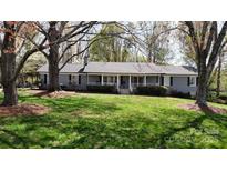 Charming single-story home with a spacious front yard and a welcoming covered porch at 2482 Kings Grant Rd, Lincolnton, NC 28092