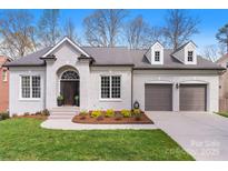 Charming brick home featuring a two-car garage and a well-manicured front yard at 4012 Cambridge Hill Ln, Charlotte, NC 28270