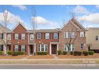 Charming townhome featuring a brick facade, well-maintained landscaping, and inviting curb appeal at 9017 Lanark Ln, Fort Mill, SC 29707
