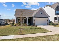 Charming single-story home with well-manicured lawn, two-car garage, and inviting front porch at 197 Tetcott St, Mooresville, NC 28115