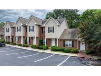 Exterior view of townhomes with manicured landscaping and designated parking spaces at 2222 15Th Ne Ave # 505, Hickory, NC 28601