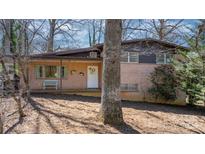Charming brick home featuring a covered front porch, complemented by a welcoming front door and landscaped front yard at 3407 14Th Sw Ave, Hickory, NC 28602