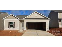 New construction home featuring neutral siding, an attached two-car garage, and a concrete driveway at 505 Maddox Dr, Shelby, NC 28152