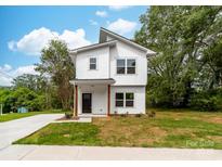 Charming two-story home with modern design, white siding, and a well-manicured front lawn at 506 Legrand St, Shelby, NC 28150