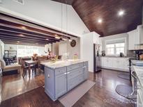Bright kitchen features a center island, stainless steel appliances, and beautiful hardwood floors at 605 Allen Way, Indian Trail, NC 28079