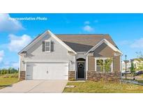 Charming single-Gathering home featuring a two-car garage, a covered front porch, and craftsman-style details at 808 Candy Dr, Statesville, NC 28677