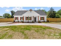 Charming home featuring wood accents, a dark roof, complemented by professionally landscaped front yard at 2363 Reepsville Rd, Lincolnton, NC 28092
