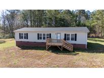 The house features a front porch, vinyl siding, dark shutters, and sits on a landscaped lot at 348 John Thrift Rd, York, SC 29745