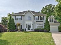 Traditional two-story home with a well-manicured lawn and mature landscaping at 557 S Portman Ln, Fort Mill, SC 29708