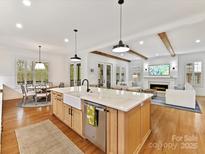 Bright kitchen with stainless appliances, granite countertops, and an open concept connecting to the living room at 911 Abilene Ln, Fort Mill, SC 29715