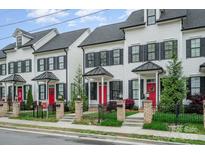Charming townhomes featuring black shutters, red doors, and well-maintained landscaping at 253 W G St, Kannapolis, NC 28081