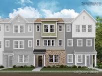 Three-story townhome showcasing a brick facade, neutral color palette, and large windows that accent the living spaces at 4104 Skyboat Cir, Fort Mill, SC 29715