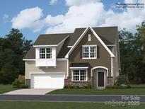 New two-story home with stone accents, attached garage and beautiful yard with lush landscaping and driveway at 4171 Skyboat Cir, Fort Mill, SC 29715