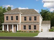 Charming two-story brick home with a well-maintained lawn and a two-car garage, perfect for a Gathering at 4203 Skyboat Cir, Fort Mill, SC 29715