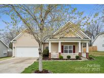 Charming single-Gathering home with manicured lawn, covered porch, and attached garage at 5386 Josephine Sw Ln, Concord, NC 28027