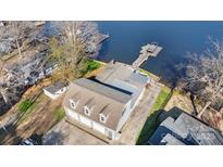 Aerial view showcasing the home's location with a dock, lake access, and three car garage at 938 Pinehaven Dr, New London, NC 28127