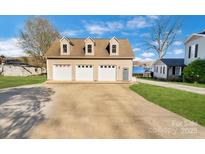 Three-car garage featuring dormer windows and access to the lake at 938 Pinehaven Dr, New London, NC 28127