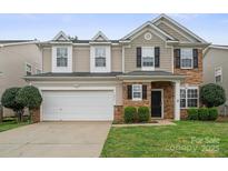 Charming two-story home with a stone facade and a two-car garage in a well-manicured neighborhood at 10241 Barrands Ln, Charlotte, NC 28278