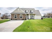 Inviting single-Gathering home with a long driveway and a well-maintained front lawn at 118 Heathrow Ln, Statesville, NC 28677