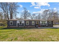 Charming single story home featuring two-tone siding and a well-maintained lawn at 119 Old Hearth Rd, Clover, SC 29710
