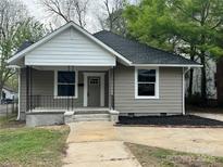 Charming single-story home with a cozy front porch and freshly mulched landscaping at 144 Walnut St, Chester, SC 29706