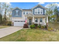 Charming two-story home with a landscaped yard, covered porch, and two-car garage at 18518 Lahaina Ln, Charlotte, NC 28278