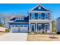 Charming two-story blue home with a well-manicured lawn and two-car garage at 1986 Thoreau Way, York, SC 29745