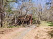 Charming rustic home with a covered front porch and driveway in a wooded setting at 2018 Fox Creek Trl, Lincolnton, NC 28092