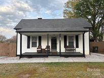 Charming single-story home with a covered front porch and a well-maintained lawn at 48 Mandalay Sw Pl, Concord, NC 28027