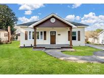 Charming home with a covered front porch, well-maintained lawn, and traditional architectural details at 703 Rankin Ave, Mount Holly, NC 28120