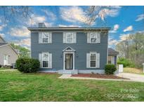 Charming two-story home with a well-manicured lawn, symmetrical windows, and inviting front entrance at 8125 Sheringham Way, Charlotte, NC 28227