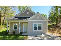 Charming single-story home with a cozy front porch and well-maintained lawn at 1124 Clouse St, Gastonia, NC 28052