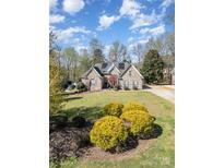 Landscaped front yard and beautiful lawn leading up to this lovely home at 124 Cedar Woods Dr, Mooresville, NC 28117