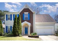 Charming two-story home featuring blue shutters, a brick facade, and a well-maintained lawn at 14525 Arbor Ridge Dr, Charlotte, NC 28273