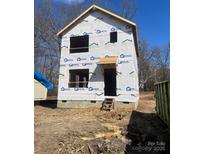 New construction shows the exterior of the house with protective moisture barrier material installed and awaiting cladding at 1587 Green Circle Dr, Gastonia, NC 28054