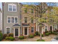 Charming townhomes showcasing varied facades, neat landscaping and covered entryways at 19737 Playwrights Way, Cornelius, NC 28031