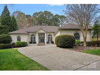 Stunning one-story home with arched windows, beautiful landscaping, and a circular driveway at 2587 Penngate Dr, Sherrills Ford, NC 28673