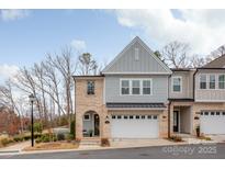 Charming townhome featuring a two-car garage, brick accents, and a welcoming front porch at 3111 Everly Enclave Way, Charlotte, NC 28210