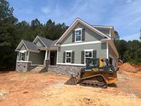 Charming home featuring stone accents, shingle siding, and a well-manicured lawn at 5947 Tipperary Dr, Denver, NC 28037