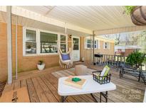 Inviting covered front porch with charming decor, seating, and natural light for relaxing outdoor living at 1747 Williams Cir, Lancaster, SC 29720