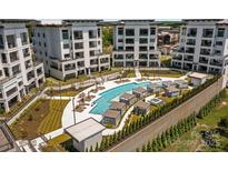 Upscale condo complex with a luxurious pool, cabanas, and well-manicured lawns at 19329 Watermark Dr # 142, Cornelius, NC 28031