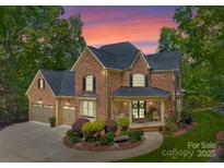Elegant brick home with a well-manicured lawn and a charming front porch perfect for relaxing evenings at 4273 Stormy Pointe Ct, Denver, NC 28037