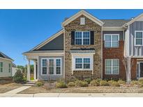 Beautiful townhouse featuring mixed brick and siding on a sunny day at 1111 Johns Walk Way, Belmont, NC 28012