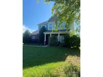 Charming two-story home with a well-manicured lawn and welcoming front porch at 4519 S Potter Rd, Monroe, NC 28112